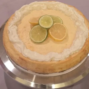 Cheesecake topped with lemon and lime slices.